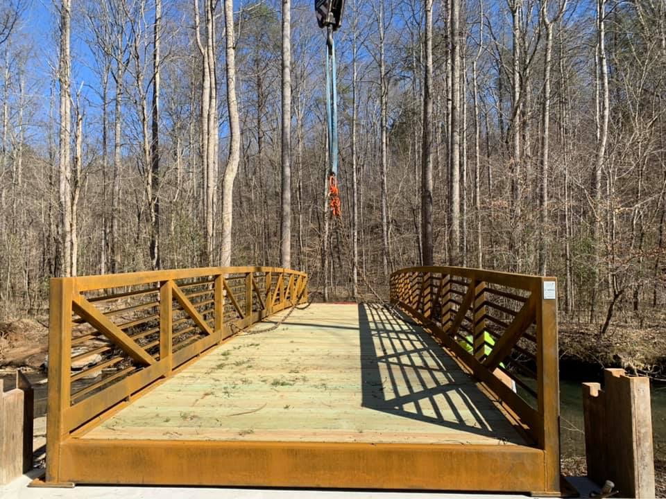 Completed timber bridge in a wooded setting