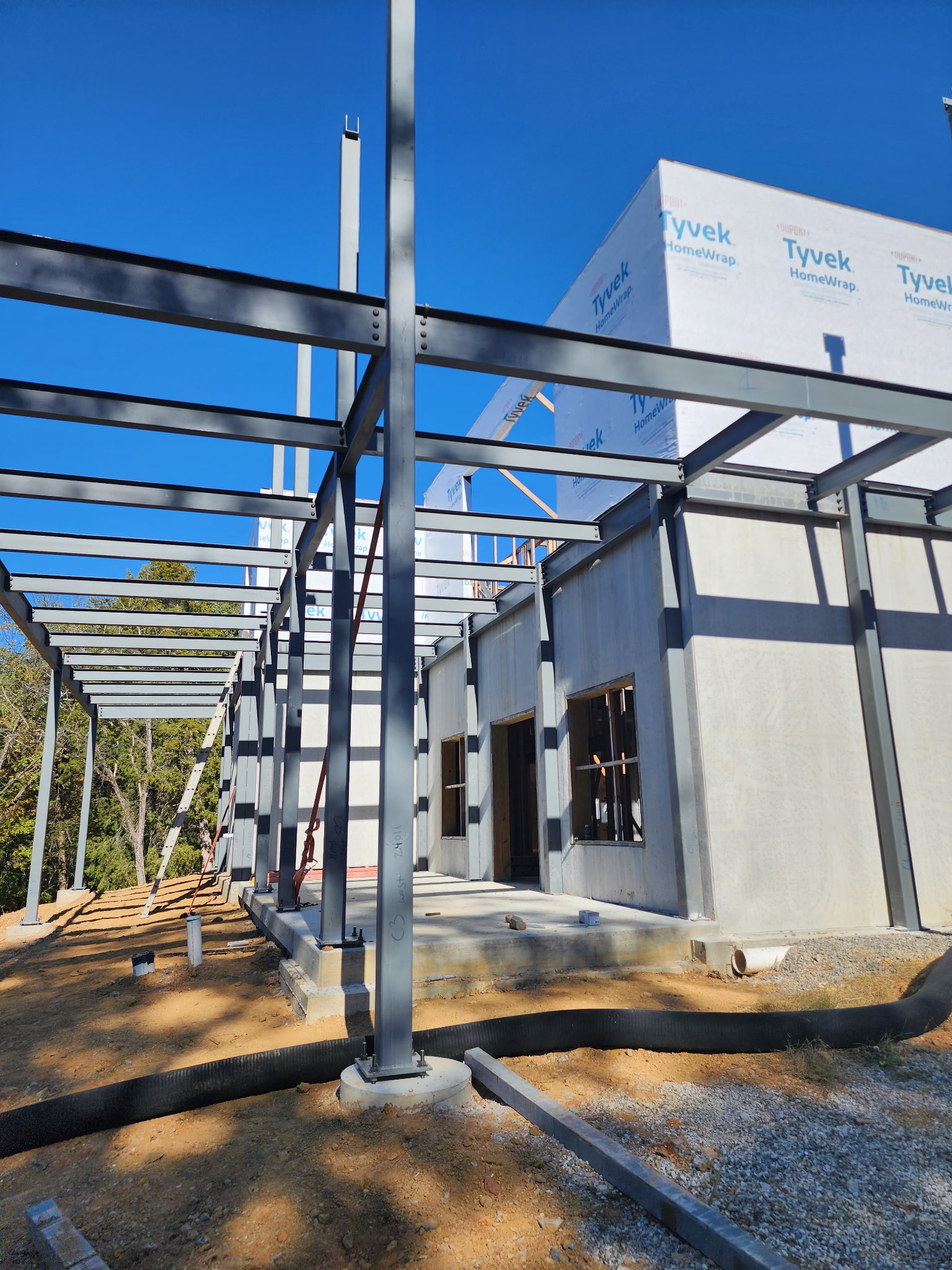 Structural steel framing and concrete wall construction in progress